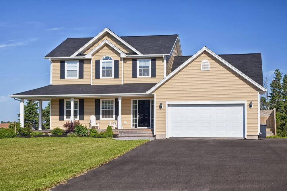 | Garage Door Services white garage door on house with tan/yellow siding